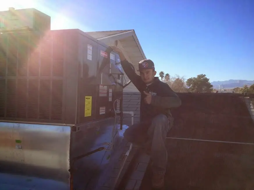 HVAC technician performing HVAC Inspection on a rooftop unit in Senatobia